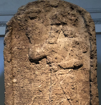 A 879 BC stela showing Ashurnasirpal II worshipping with his right hand raised toward the symbols of his gods.