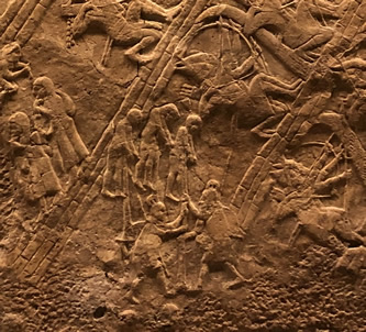 Lachish siege - Captives leaving the city, execution by impalement, while Assyrians continue the siege of the city