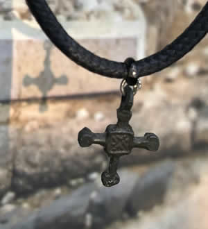 Byzantine bronze cross pendant from 800 AD worn by a Christian in Bulgaria near the Danube River in Eastern Europe. Both sides engraved with "X" which is the Greek letter Chi, or X, the first letter in "Christos"