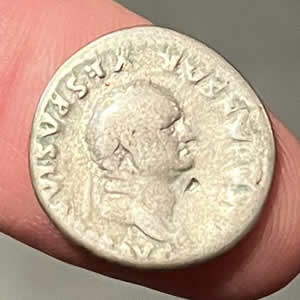 74 AD Vespasian silver denarius minted in Rome 74 AD obverse Vespasian, IMP CAESAR VESP AVG meaning Imperator Caesar Vespasianus Augustus