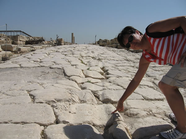 Toni Wiemers points at an ancient Roman Road in Sepphoris, Israel.
